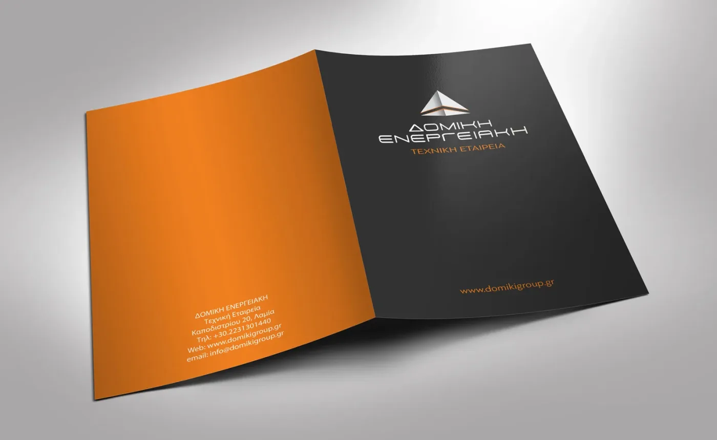 Domiki Energeiaki presentation folder — graphite cover with the logo, orange inner face with contact details